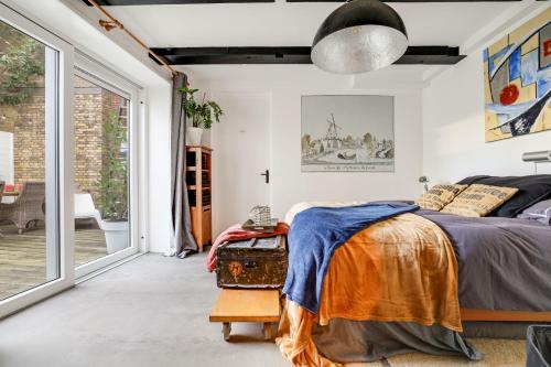 a bedroom with a bed and a large window at Prachtig appartement in hartje Sneek in Sneek