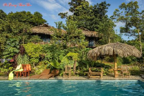 a resort with a swimming pool and a house at PuLuong BamBoo in Hương Bá Thước