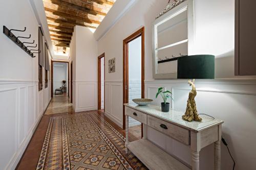 einen Flur mit einem Konsole-Tisch und einem Spiegel in der Unterkunft Habitat Apartments Grace in Barcelona