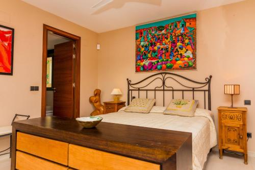 a bedroom with a bed and a painting on the wall at Albamar Duplex Apartment Javea Arenal by Rock Rentals in Jávea