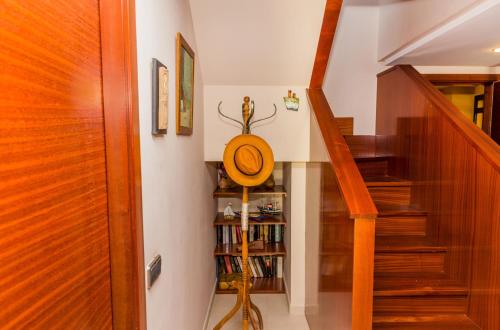 a room with a staircase with a book shelf at Albamar Duplex Apartment Javea Arenal by Rock Rentals in Jávea