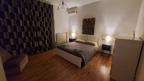 a bedroom with a bed and a couch and a chair at Le Strelizie in Arnesano