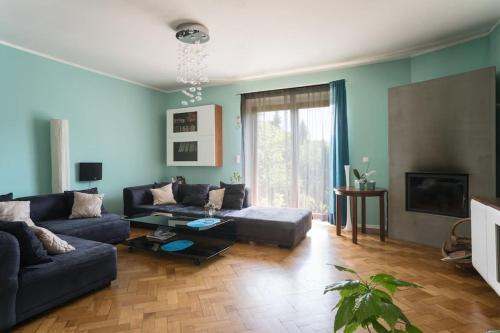 a living room with a couch and a table at Dom z ogrodem blisko centrum in Poznań