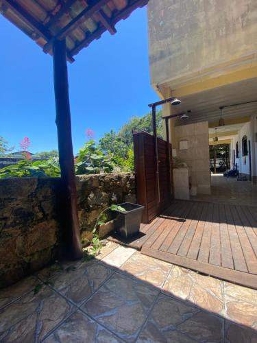 an outside view of a house with a wooden door at Pousada Korui in Abraão