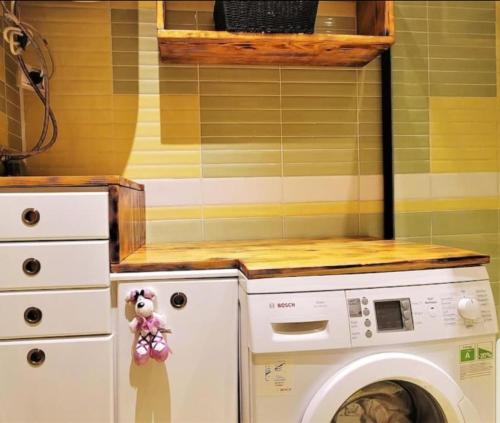 a laundry room with a washer and dryer at Malda's Apartment in Pristina