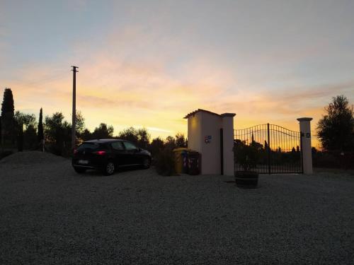 a car parked in a gravel lot next to a gate at Agriturismo Villa Adimari in Cerreto Guidi