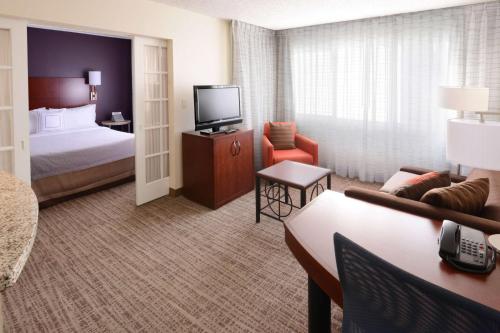 a hotel room with a bed and a television at Sonesta ES Suites Dallas Central Expressway in Dallas