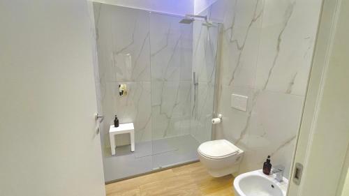 a bathroom with a shower and a toilet and a sink at Casa Manzoni Deluxe MXP Town Center in Gallarate