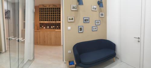 a blue chair in a room with a wine cellar at HIRUNDO- villa with saunas and hot tub 