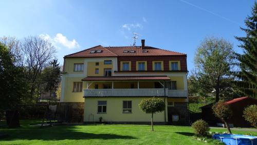 a large yellow house with a red roof at penzion Horácko in Unčín