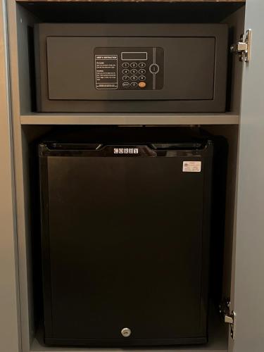 a microwave oven sitting on top of a refrigerator at Hotel Indigo - Cardiff by IHG in Cardiff