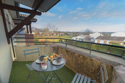 a table and chairs on the balcony of a house at Magnifique appartement T2 rénové Aux vendanges Gaillac in Gaillac