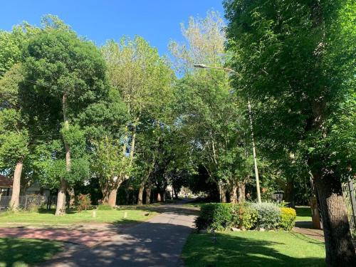 a path in a park with trees and grass at Mar y Asados - Chalet hasta 19 huéspedes con dos Parrillas in Mar del Plata