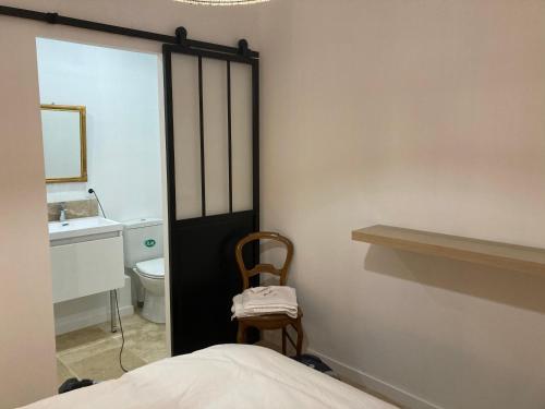 a bedroom with a bed and a sink and a mirror at La Rolande in Aix-en-Provence