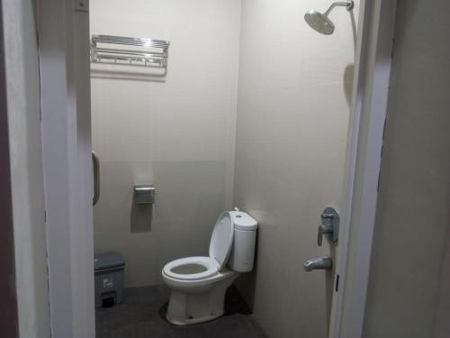 a bathroom with a white toilet in a stall at Griya Sambilegi in Yogyakarta