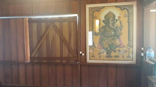a door with a picture of a deity on the wall at Solar da Lagoa in Florianópolis