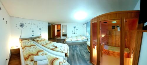 a living room with two beds in a room at Apartma na Ravnicah in Cerkno
