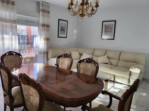 a living room with a table and a couch at Paradise of Dreams Apartamentos - LA CARRERA in Adra