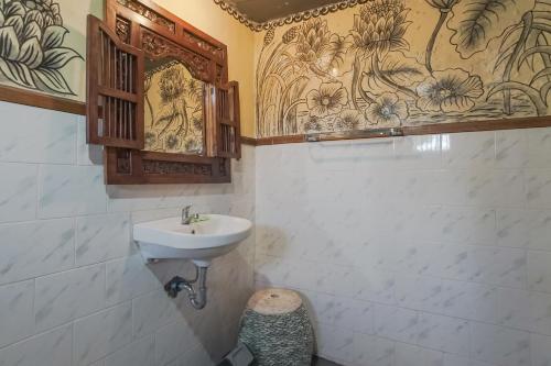 a bathroom with a sink and a toilet at Ubud Kerta City Hotel in Ubud