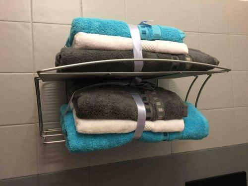 a bunch of towels on a rack in a bathroom at Ferienwohnung Casa Belvedere in Brezzo