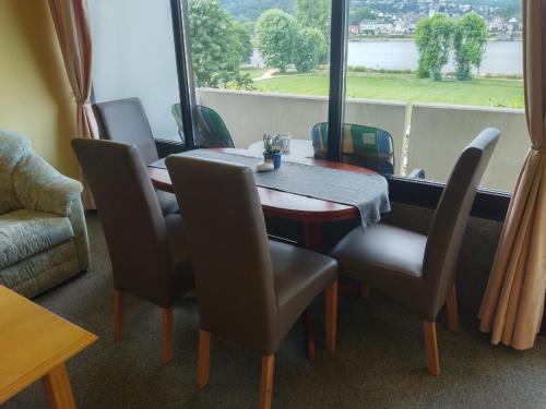 uma sala de jantar com uma mesa e cadeiras e uma janela em Kati Appartement em Bad Hönningen