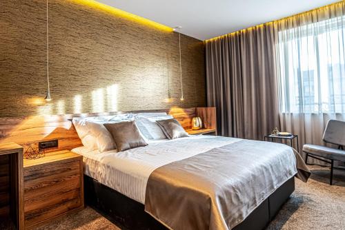 a bedroom with a large bed and a window at Calma Luxury Rooms in Split