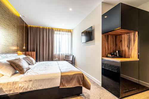 a hotel room with a bed and a desk at Calma Luxury Rooms in Split