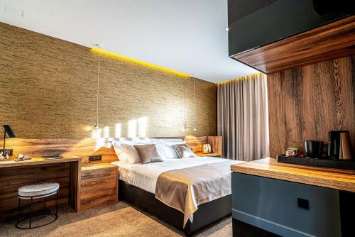 a bedroom with a bed and a desk with a desk at Calma Luxury Rooms in Split