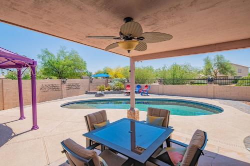 a patio with a table and chairs and a pool at Boho Chic Arizona Villa w Pool & Mini Golf in Casa Grande