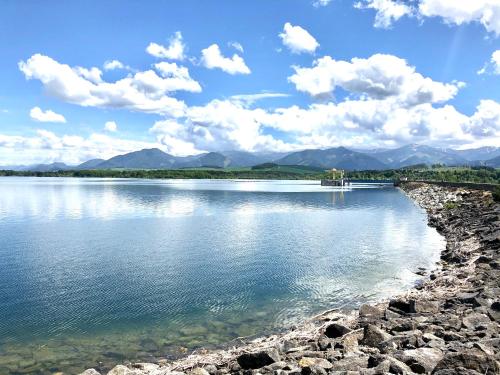 a large body of water with mountains in the background at Wellness Villa Liptov in Liptovská Sielnica