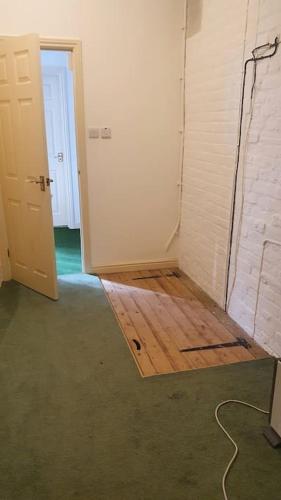 a room with a door and a wooden floor at Canalside Manor House Annexe with Secure Parking in Heath and Reach