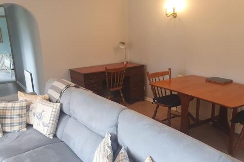a living room with a couch and a dining room table at Canalside Manor House Annexe with Secure Parking in Heath and Reach