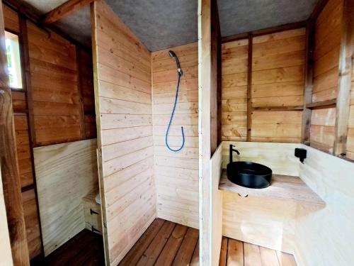een kleine houten sauna met een douche. bij De Koekoek in Brugge