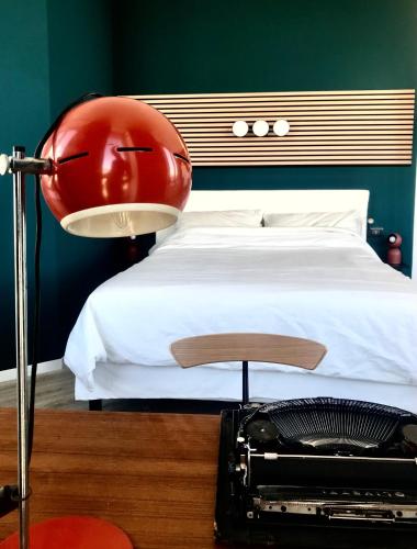 a bedroom with a bed with a red helmet on it at Central penthouse with spectacular sea and city views in Genova