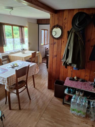 a kitchen and dining room with a table and chairs and a room with a kitchen at Chata Štěpánka u řeky Sázavy in Ledeč nad Sázavou