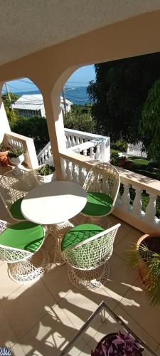 a patio with chairs and a table on a balcony at Sunflower Cottage in Hopewell
