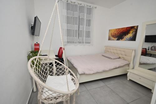 Zimmer mit einem Bett und einer Schaukel in der Unterkunft דירה luxury על הפארק חניה חינם in Migdal Afeq