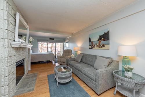 a living room with a couch and a fireplace at 105A Efficiency One Bath in Oakland