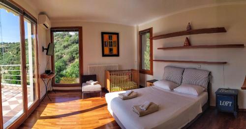 a bedroom with a bed and a large window at Villa Orgoni in Platanias