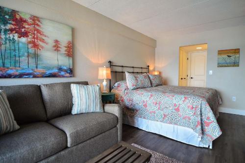 a living room with a couch and a bed at 202B One Bedroom One Bath in Oakland