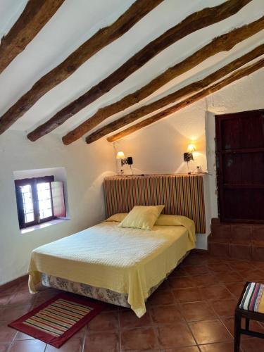 a bedroom with a bed in an attic at Cortijo EL COSIO in Benamaurel