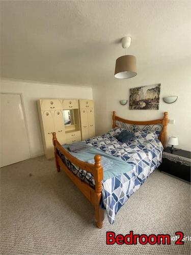 a bedroom with a bed with a blue and white comforter at Super deluxe extra large 3 bedroom apartment in Stanley