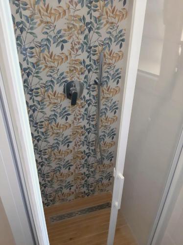 a shower in a bathroom with a wall at Residence Vigna del Mare in Gabicce Mare
