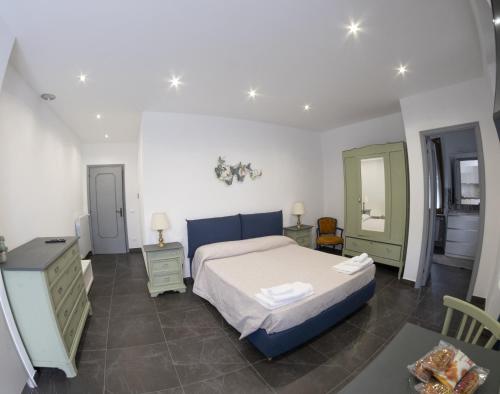 a bedroom with a bed and a dresser and a mirror at Hotel Da Bruno in Rocchetta Ligure