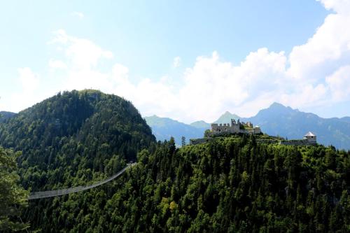 a road on a hill with a castle on it at RIMA Apart‘s in Heiterwang