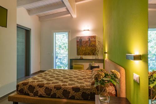 a bedroom with a bed and a green wall at Anima Mundi in Curtatone