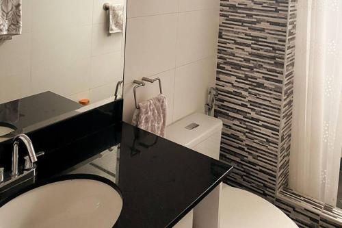 a bathroom with a sink and a toilet and a shower at Lux apt with ocean view within 10min from LarcoMar in Lima