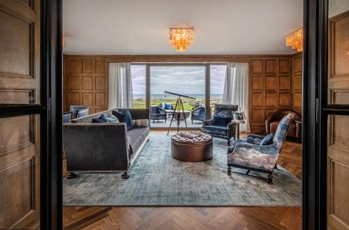 a living room with a couch and chairs at Old Course Hotel St Andrews in St. Andrews