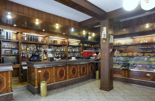 a bar in a restaurant with shelves of alcohol at Hotel Da Bruno in Rocchetta Ligure