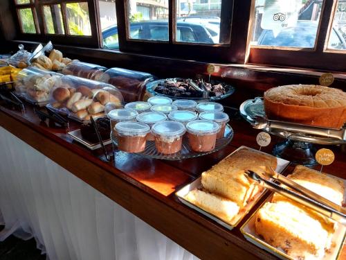 a buffet with many different types of food on a table at Pousada Solar de Itaúna in Saquarema